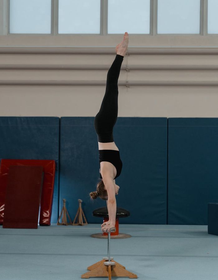 Man practicing balanced movement in a minimalist gym setting